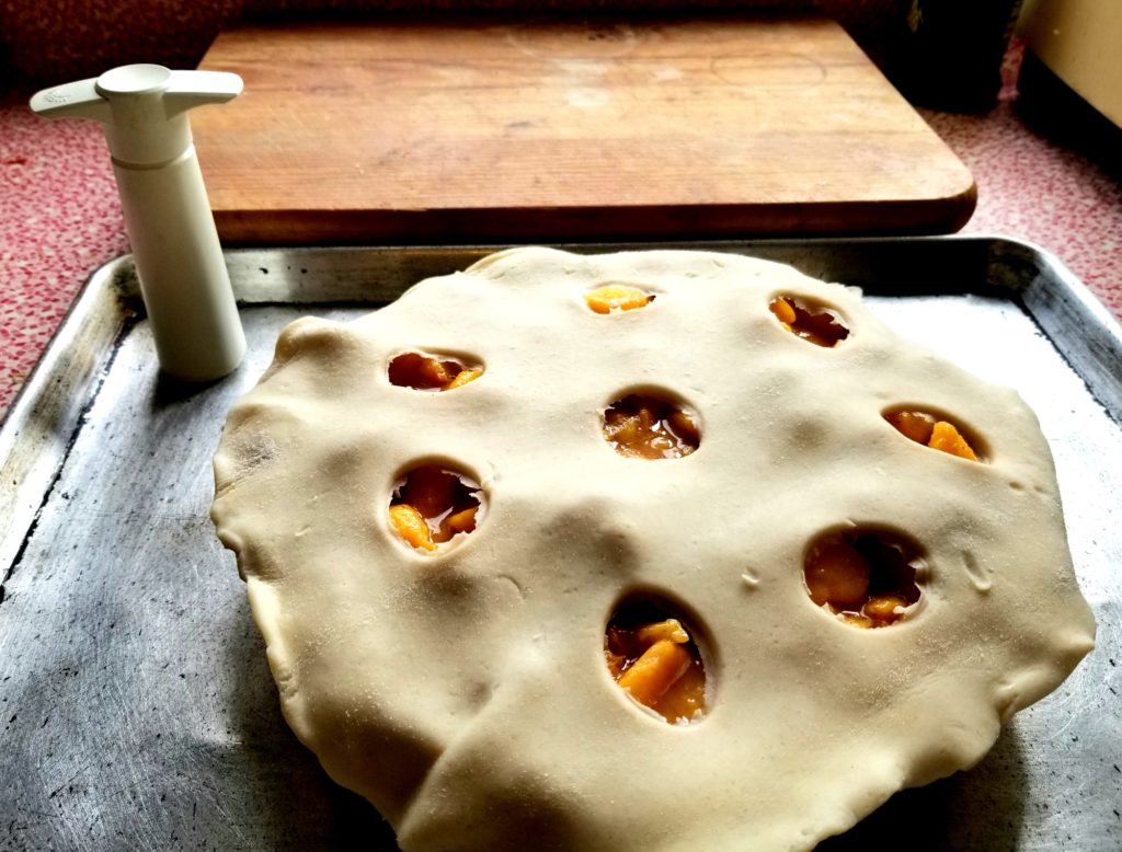 Uncrimped pie crust. Wine sealer I used to make holes in the upper left corner.