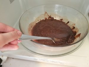 Using the microwave to melt the butter and Baker's chocolate for the brownies.